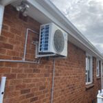 Outdoor AC unit installed on wall brackets at Russel Lea area